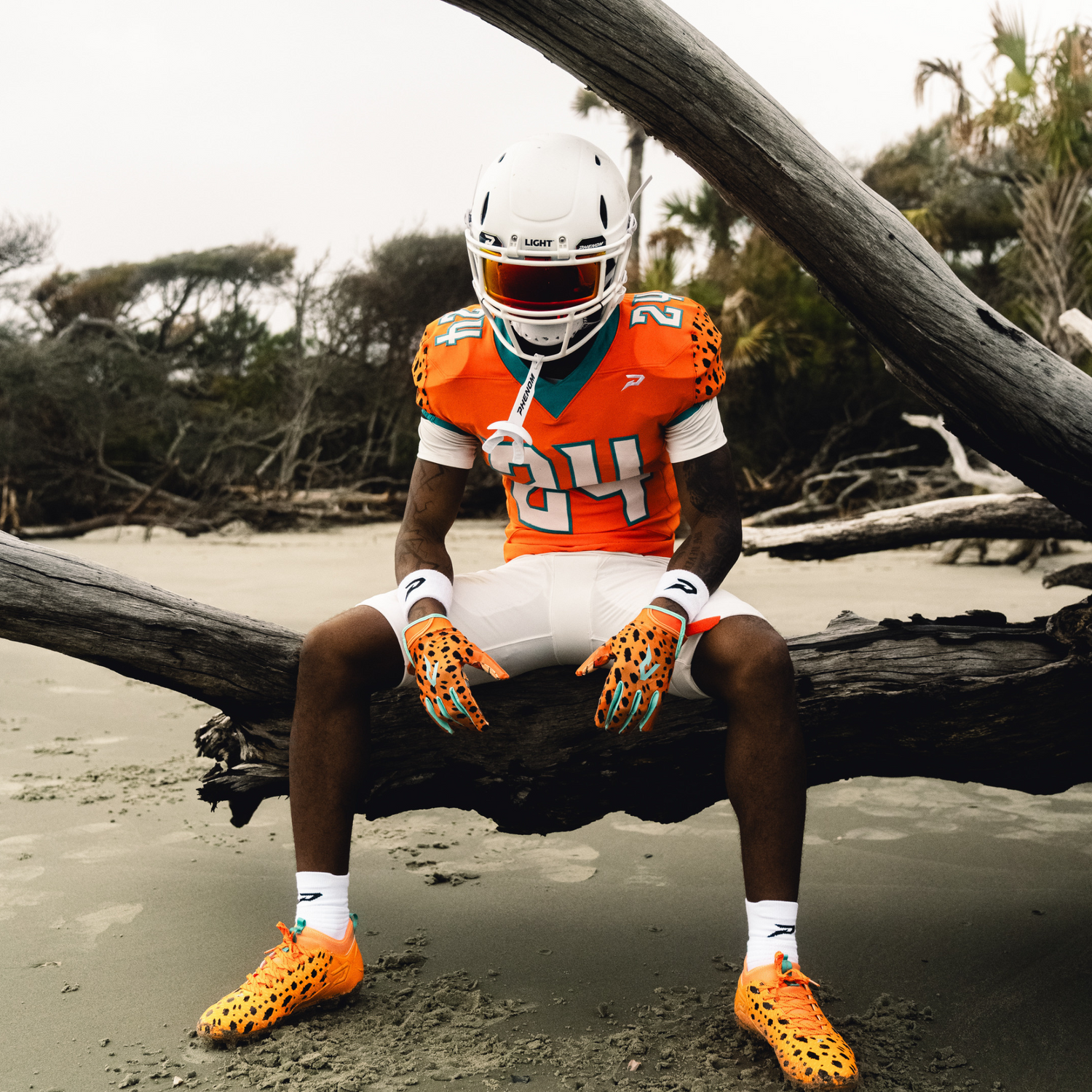 Football player wearing a LIGHT Helmets LS2 football helmet while wearing Phenom visor, gloves and cleats